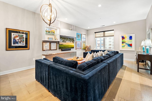 living room with a chandelier and light wood-type flooring