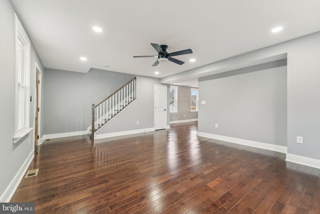 unfurnished living room with dark wood-type flooring and ceiling fan