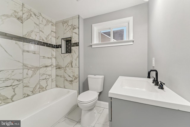 full bathroom featuring vanity, tiled shower / bath, and toilet