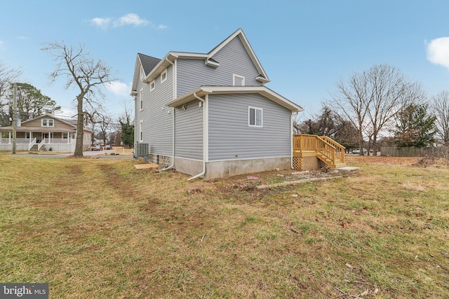 view of home's exterior featuring central AC unit and a yard