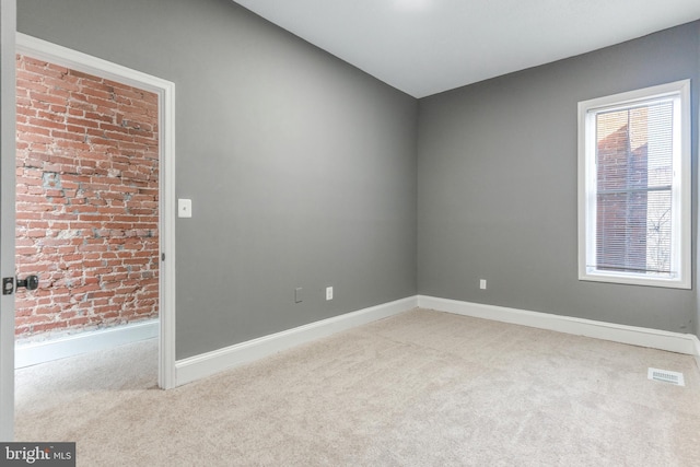 unfurnished room featuring light carpet