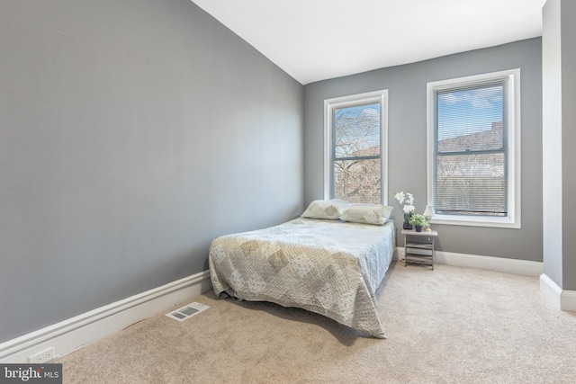 bedroom with vaulted ceiling and carpet