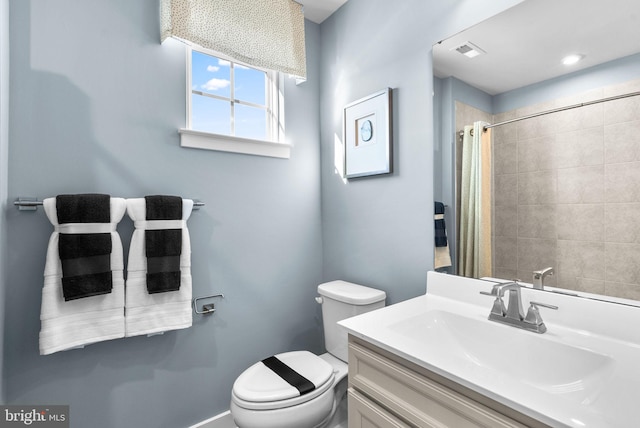 bathroom with vanity, toilet, and curtained shower