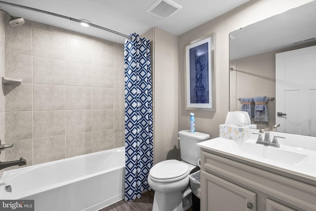 full bathroom featuring hardwood / wood-style flooring, vanity, toilet, and shower / bath combo with shower curtain