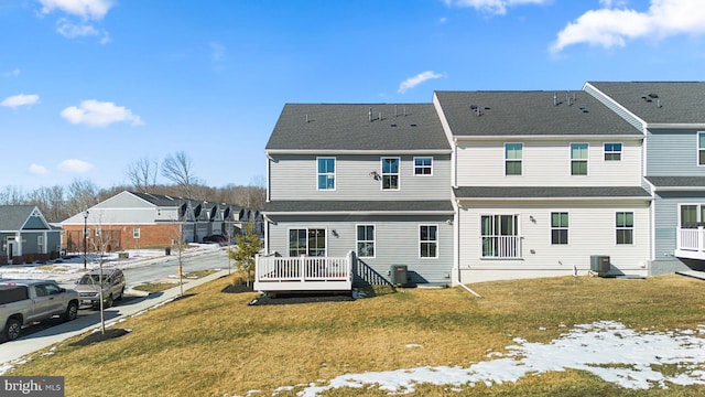 rear view of house featuring a lawn, a deck, and central air condition unit