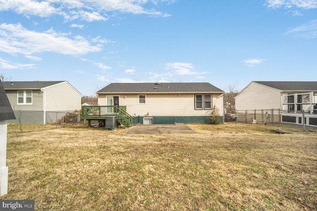 back of property with a deck, central AC, a lawn, and fence private yard