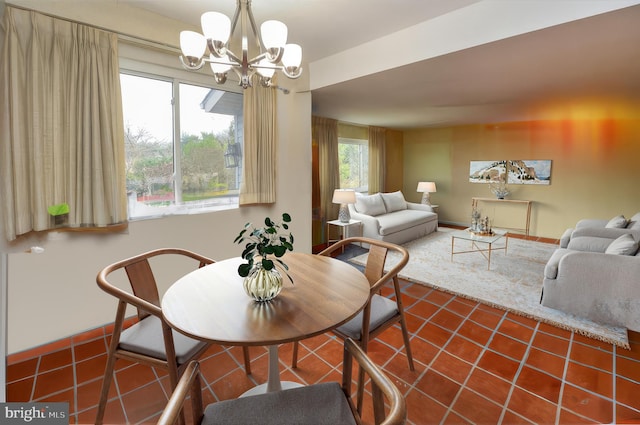 tiled dining space featuring a notable chandelier