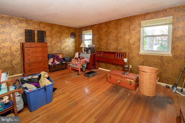 sitting room featuring a healthy amount of sunlight and hardwood / wood-style flooring