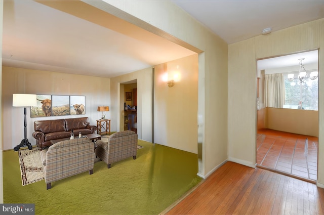 living room with an inviting chandelier and wood-type flooring