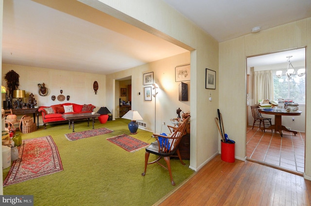 rec room with hardwood / wood-style floors and a notable chandelier