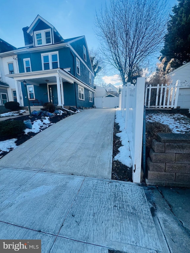 snow covered property featuring a porch