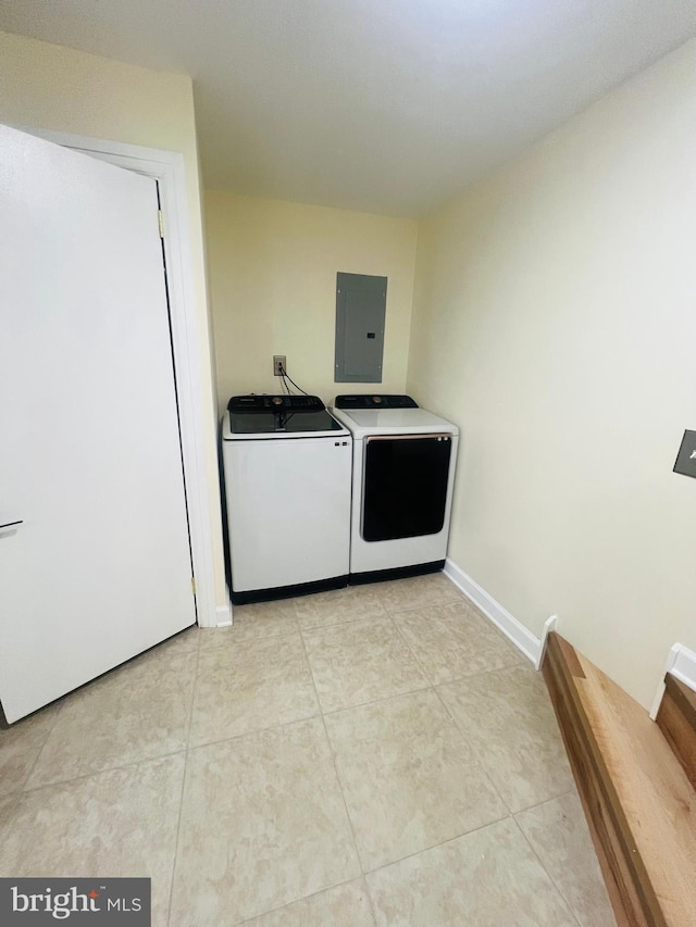 washroom with washer and dryer, light tile patterned floors, and electric panel