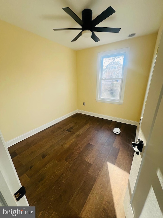 spare room featuring ceiling fan and dark hardwood / wood-style flooring