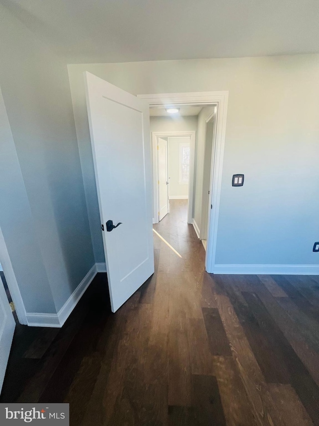 hallway featuring dark hardwood / wood-style flooring