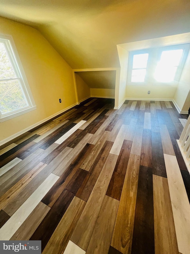 bonus room featuring dark hardwood / wood-style flooring and vaulted ceiling