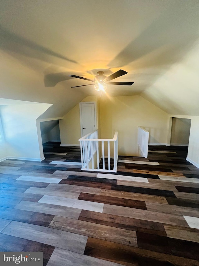 additional living space featuring dark hardwood / wood-style flooring, ceiling fan, and vaulted ceiling