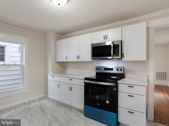 kitchen featuring white cabinetry and appliances with stainless steel finishes