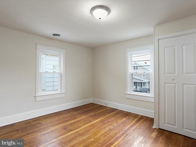 spare room with wood-type flooring