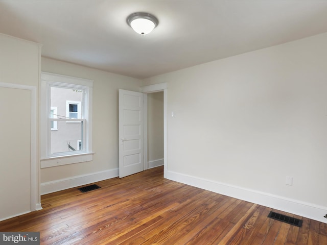 empty room featuring wood-type flooring