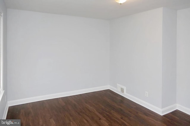 unfurnished room featuring dark hardwood / wood-style flooring