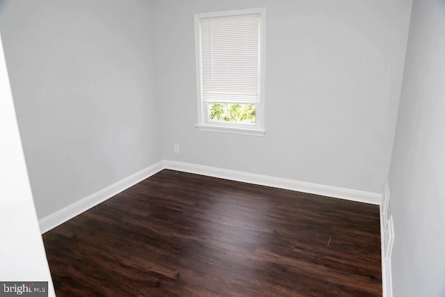 spare room featuring dark wood-type flooring