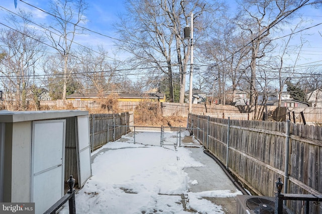 yard covered in snow with central air condition unit