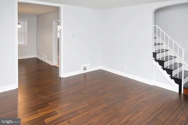 empty room with dark hardwood / wood-style flooring