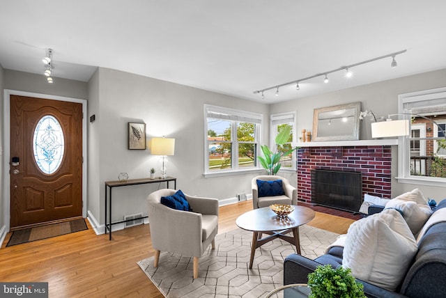 living room with light hardwood / wood-style flooring and a fireplace