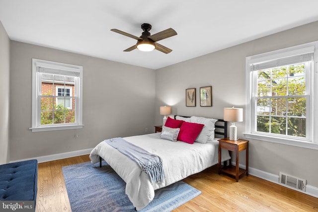 bedroom with light hardwood / wood-style flooring and ceiling fan