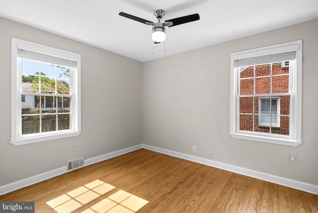 spare room with ceiling fan and hardwood / wood-style floors