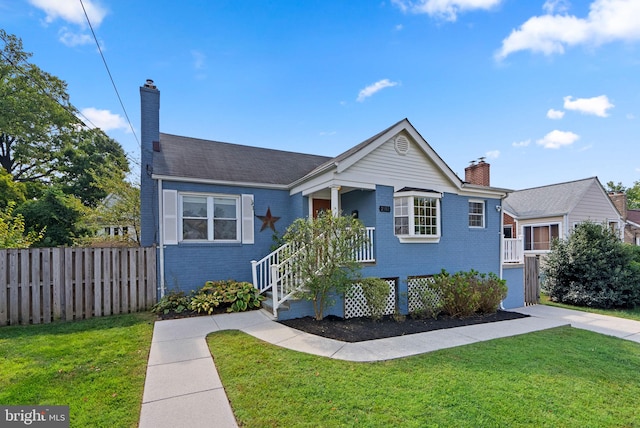 bungalow-style house featuring a front lawn