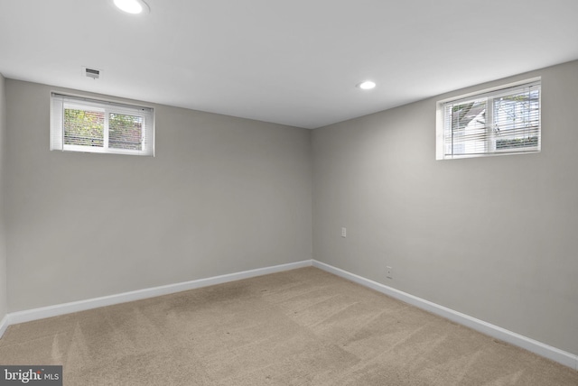 basement with light carpet and a healthy amount of sunlight