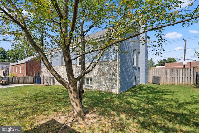 view of side of property with a lawn