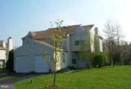 view of side of property with a garage and a yard