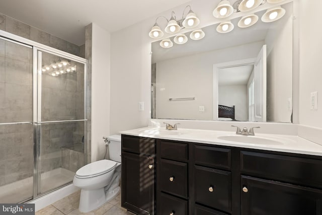 bathroom with vanity, toilet, a shower with shower door, and tile patterned flooring