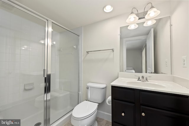 bathroom featuring tile patterned floors, toilet, a shower with door, and vanity