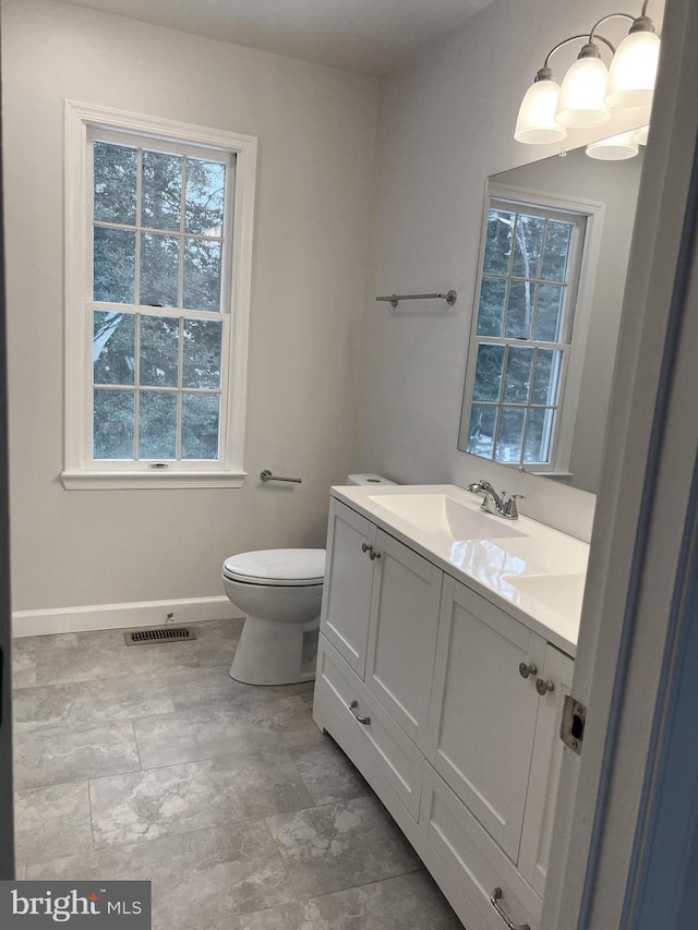 bathroom featuring toilet and vanity