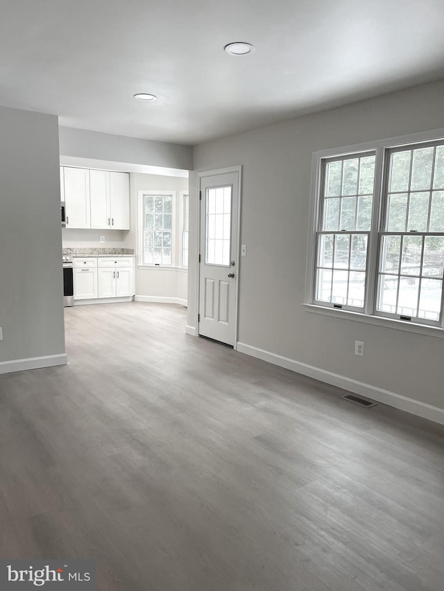 unfurnished living room with wood-type flooring