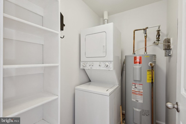 clothes washing area with water heater and stacked washer / dryer