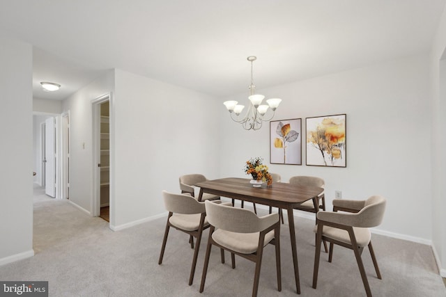 carpeted dining area featuring a notable chandelier