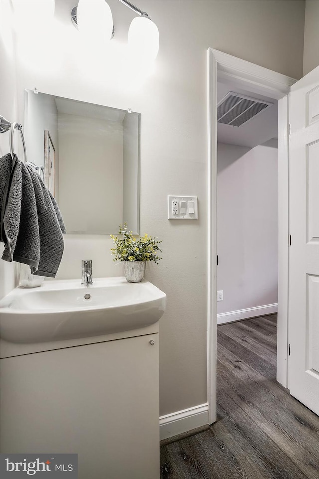 bathroom with hardwood / wood-style flooring and vanity