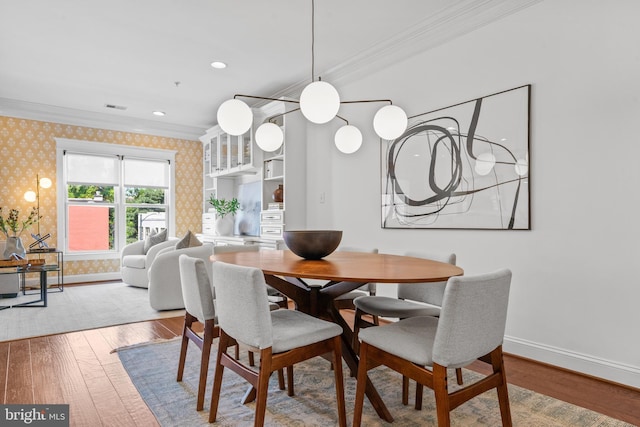 dining room featuring ornamental molding and wood-type flooring