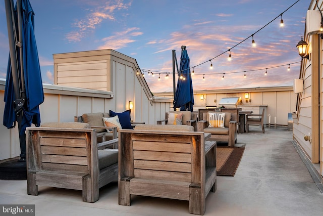 patio terrace at dusk featuring outdoor lounge area