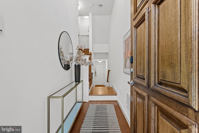 entryway with dark hardwood / wood-style flooring