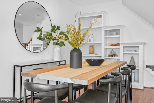 dining area featuring crown molding and wood-type flooring