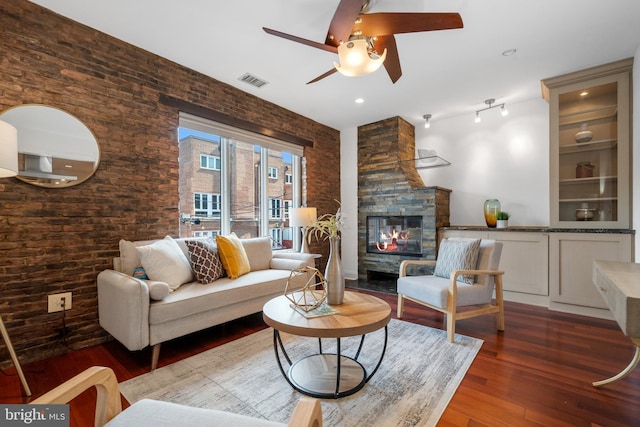 1625 Q St NW Unit 203, Washington, DC 20009 - living room with ceiling fan, wood finished floors, a multi sided fireplace, and brick wall