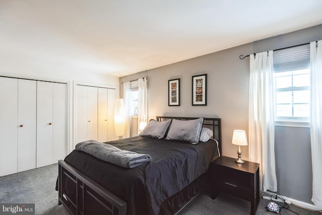 carpeted bedroom featuring multiple closets