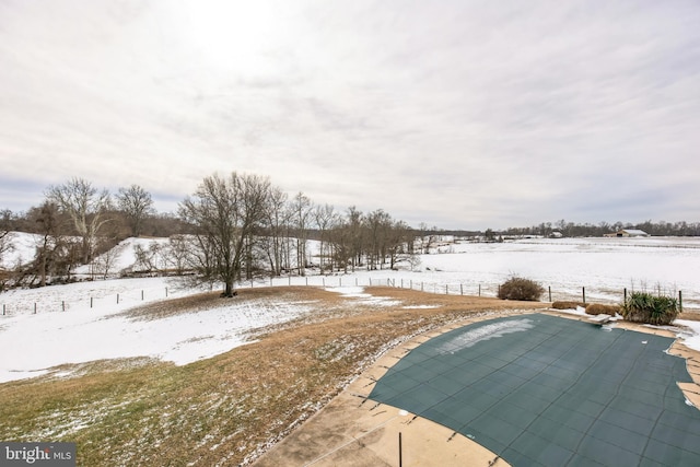 snowy yard featuring a covered pool and a patio