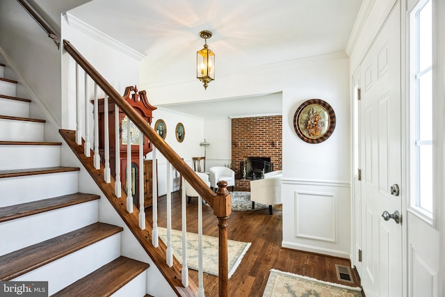 entryway featuring dark hardwood / wood-style floors and ornamental molding