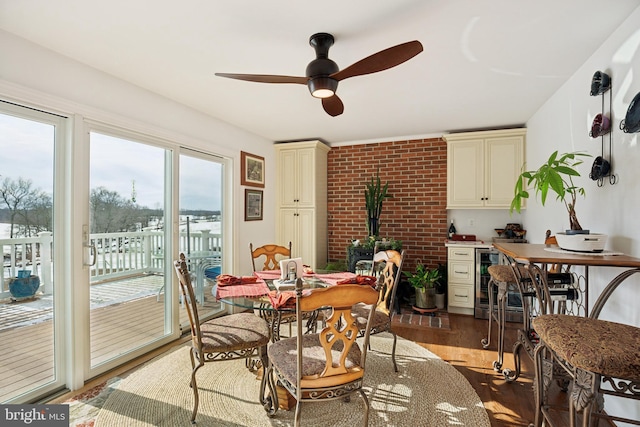 dining space with ceiling fan, wood-type flooring, and wine cooler